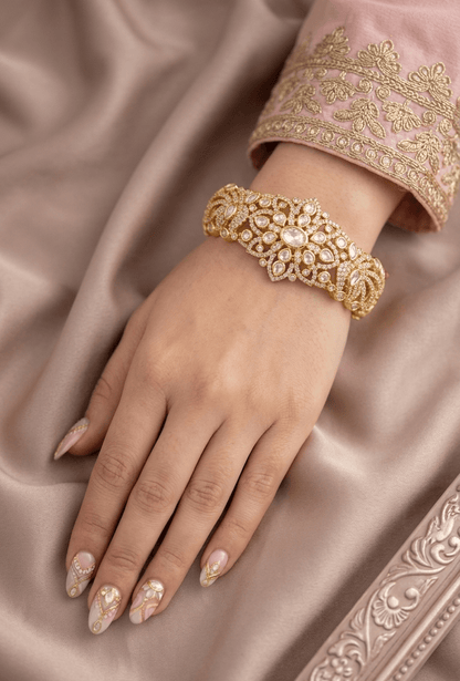 Single broad rigid kada with a carved frame and dense foil-set Kundan, gold-plated, by Sirini Jewellery
